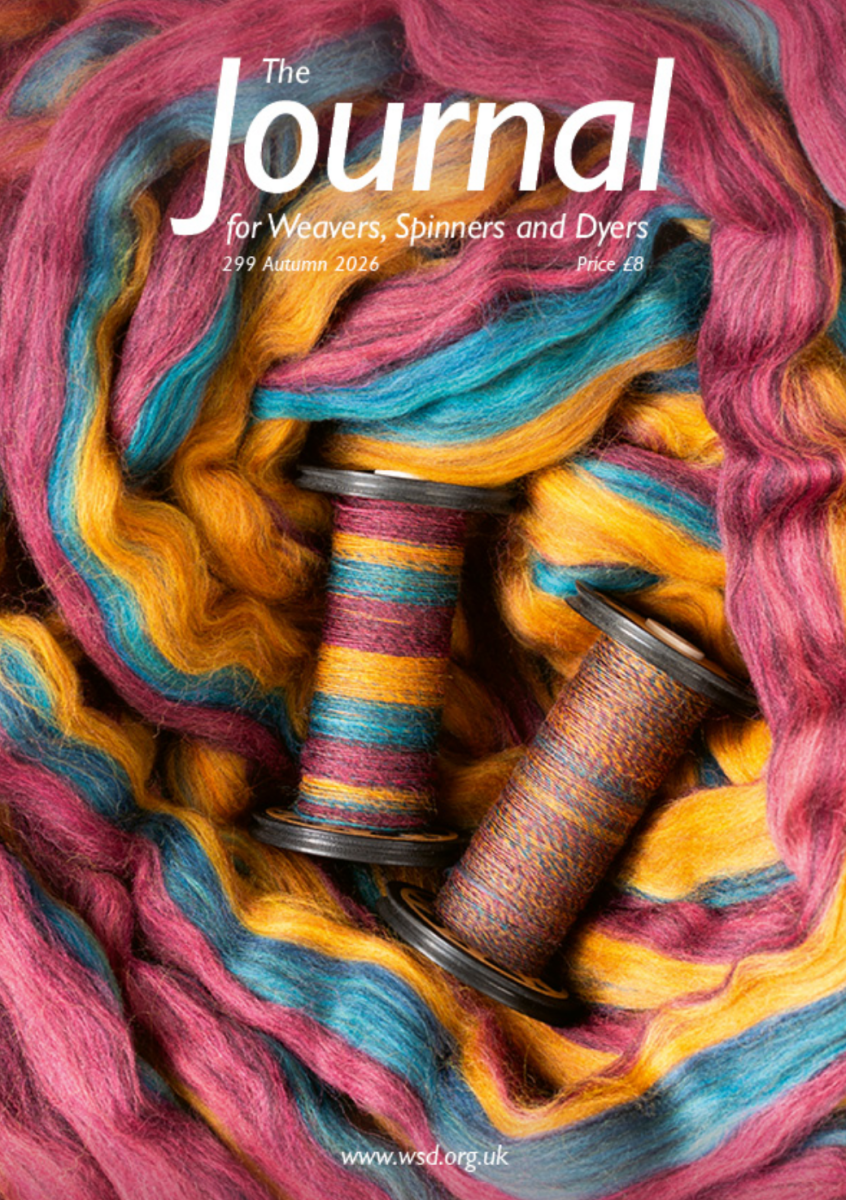Cover of The Journal For Weavers, Spinners and Dyers - Issue 299, Autumn 2026 Magazine features two spools wrapped in colorful yarn, surrounded by loose strands of pink, yellow, blue, and orange fiber. Announcing the Autumn 2026 issue for fiber art enthusiasts—including weavers and spinners—who delight in creative expression and vibrant textures.