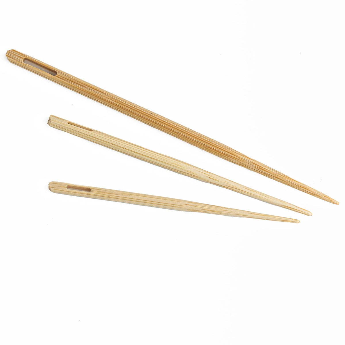 The N. Jefferson Jumbo Bamboo Blunt Needles (set of 3) each have a tapered point and elongated eye, making them ideal for weaving. The three needles come in assorted lengths and are arranged parallel on a white background.
