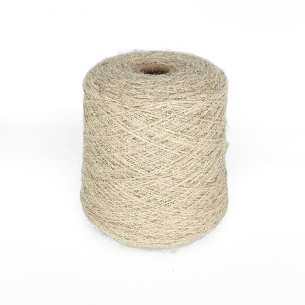 A large cone of Bartlett Maine Wool, Sport Weight by Bartlettyarns is neatly wound, standing upright against a white background. Its texture features a homespun appearance with visible fibrous, natural details.
