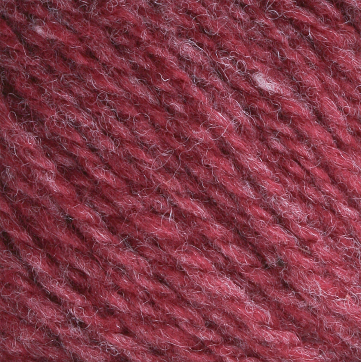 Close-up of Bartlettyarns Maine Wool Yarn (Fisherman 2-Ply) fibers in maroon and light pink heathered shades, highlighting the brand’s soft, slightly fuzzy texture with diagonally twisted strands.