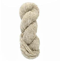 A skein of Bartlettyarns Maine Wool Yarn (Fisherman 2-Ply) by Bartlettyarns, in natural undyed beige and worsted weight, tightly twisted into a coil against a plain white background.