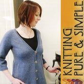 A woman in a fitted, light blue Neckdown Swing Cardigan #118 by Knitting Pure & Simple stands next to a coffee machine. Yellow text on the right shows the brand name.