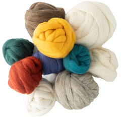 A top view of Halcyon Yarn Fiber Starter showcases several colorful wool bundles—white, gray, yellow, blue, green, teal, red, and brown—arranged in a circle for spinning yarn or wool crafting.