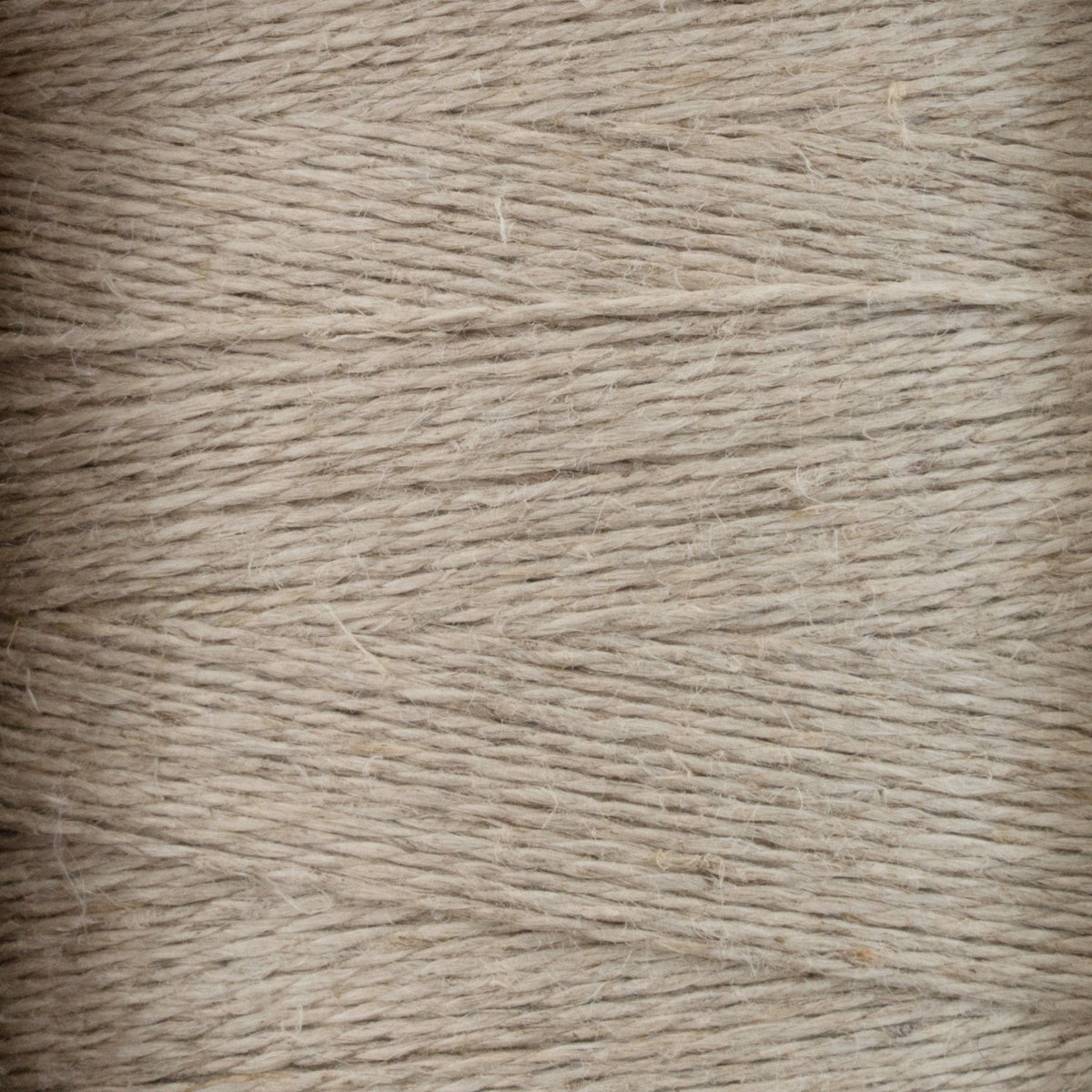 Close-up of Newport 16/2 Linen Yarn Mini-cone by Halcyon Yarn in beige, highlighting the tightly wound parallel rows and distinct linen strands.