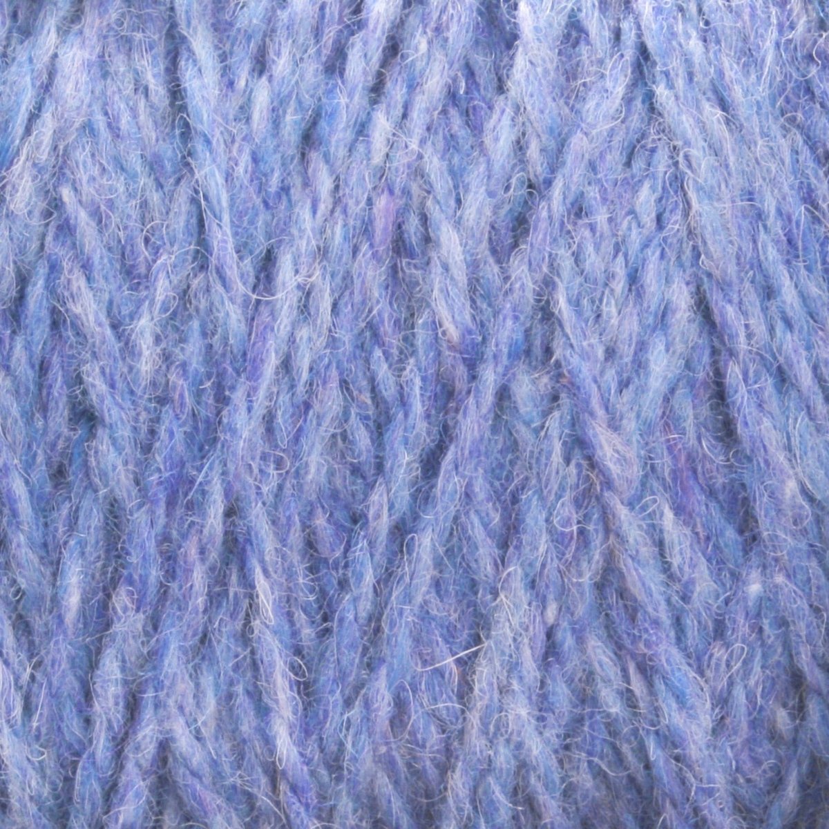 Close-up of soft, fuzzy, blue and purple Harrisville Designs Harrisville Highland - Cones yarn strands intertwined in a textured, woven pattern—perfect for creating rustic sweaters or cozy yarn blankets.