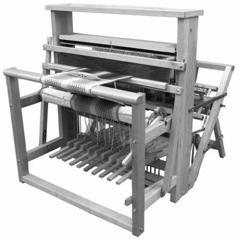 A black and white photo of the Leclerc Looms Nilus II 8-Shaft Floor Loom, a jack loom with back-hinge treadles, shows threads stretched across the frame with multiple levers, beams, and pedals for versatile textile production.