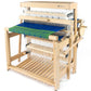 The Louet Inc. Louët Spring 2, an 8 or 12 shaft floor loom, features blue and green fabric partially woven on its countermarche system, with various threads and beams visible throughout the structure for a unique weaving experience.