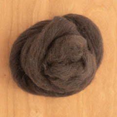 A coiled bundle of dark brown Corriedale Wool Top fiber for spinning yarn.