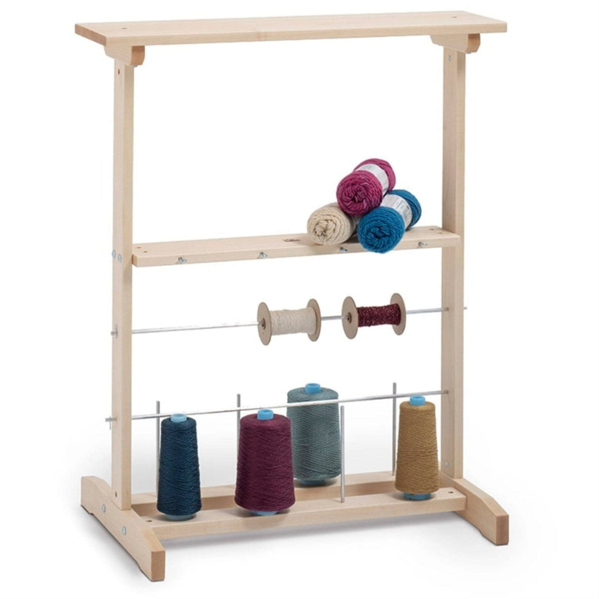 The Schacht Winding Station by Schacht Spindle Co. is a wooden cone spool rack that holds multiple spools and cones of yarn in various colors, such as blue, pink, beige, and brown, displayed across three levels. It’s ideal for organizing your winding area or pairing with ball winders to keep your workspace tidy and your yarn easily accessible.
