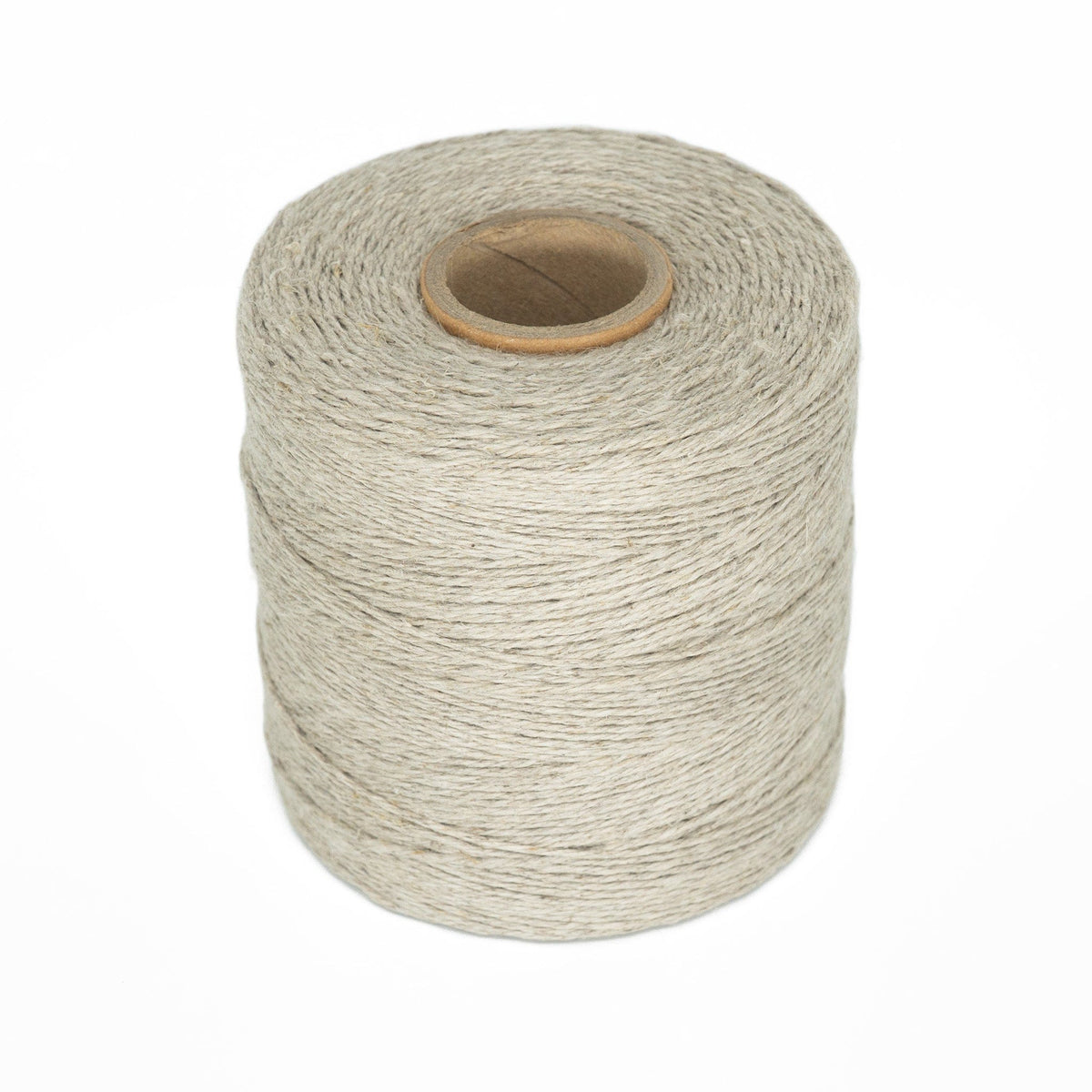 A spool of Soft Finish Linen Warps by Kingfisher Yarn & Fibre, in light grey, is tightly wound around a cardboard core—perfect for tapestry weaving or linen warps—displayed against a plain white background.