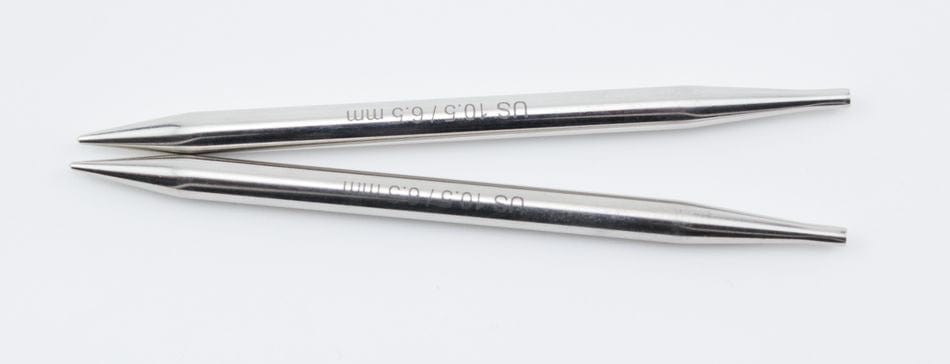 Two 5" Knit Pro (Knitters Pride) Nova Metal Interchangeable Knitting Needles by Accessories Unlimited lie parallel on a white background. The cylindrical needles have pointed ends and engraved numbers.
