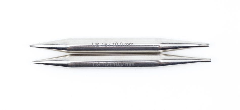 Two silver Knit Pro Nova Metal Interchangeable Knitting Needles, 5", by Accessories Unlimited, with size markings, lie parallel on a white background, showcasing their sleek design.