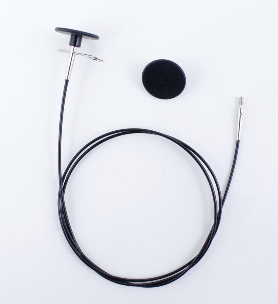 The Accessories Unlimited Knit Pro Interchangeable Circular Needle Cord for Dreamz and Nova is shown coiled with a round mounting pad, featuring black and silver accents, displayed on a white background.