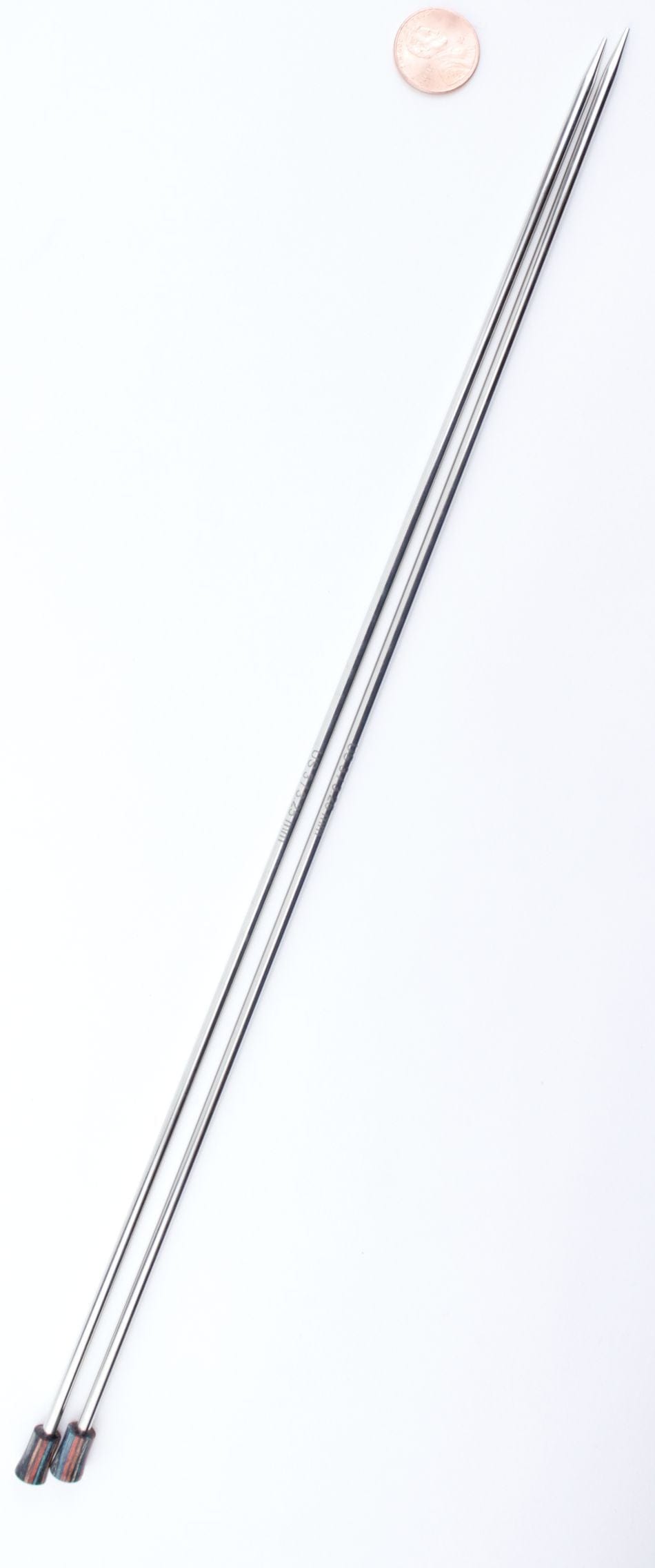 Two Accessories Unlimited Knit Pro (Knitters Pride) Nova Metal Single Point Knitting Needles, 10" or 14", with pointed tips, are placed parallel on a white background, a coin near the top right for size reference.