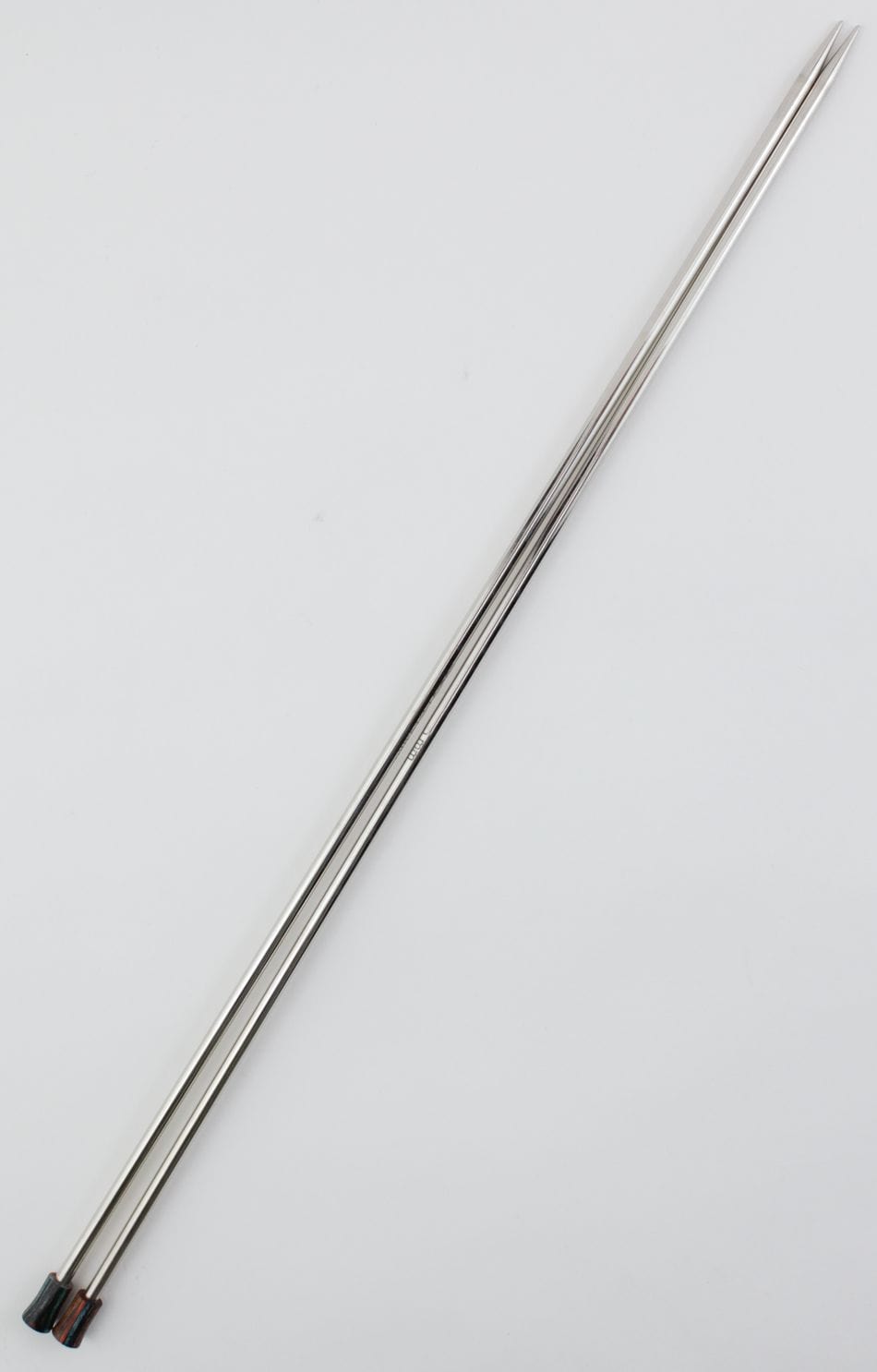 Two long, silver Knit Pro (Knitters Pride) Nova Metal Single Point Knitting Needles by Accessories Unlimited are placed diagonally on a plain white background.