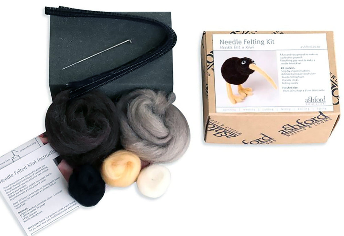 The Ashford Needle Felting Kit by Ashford Handicrafts Limited includes colorful wool, felting needle, black pipe cleaner, instructions, foam pad, and a box with a kiwi bird design—ideal for beginner needle felters.