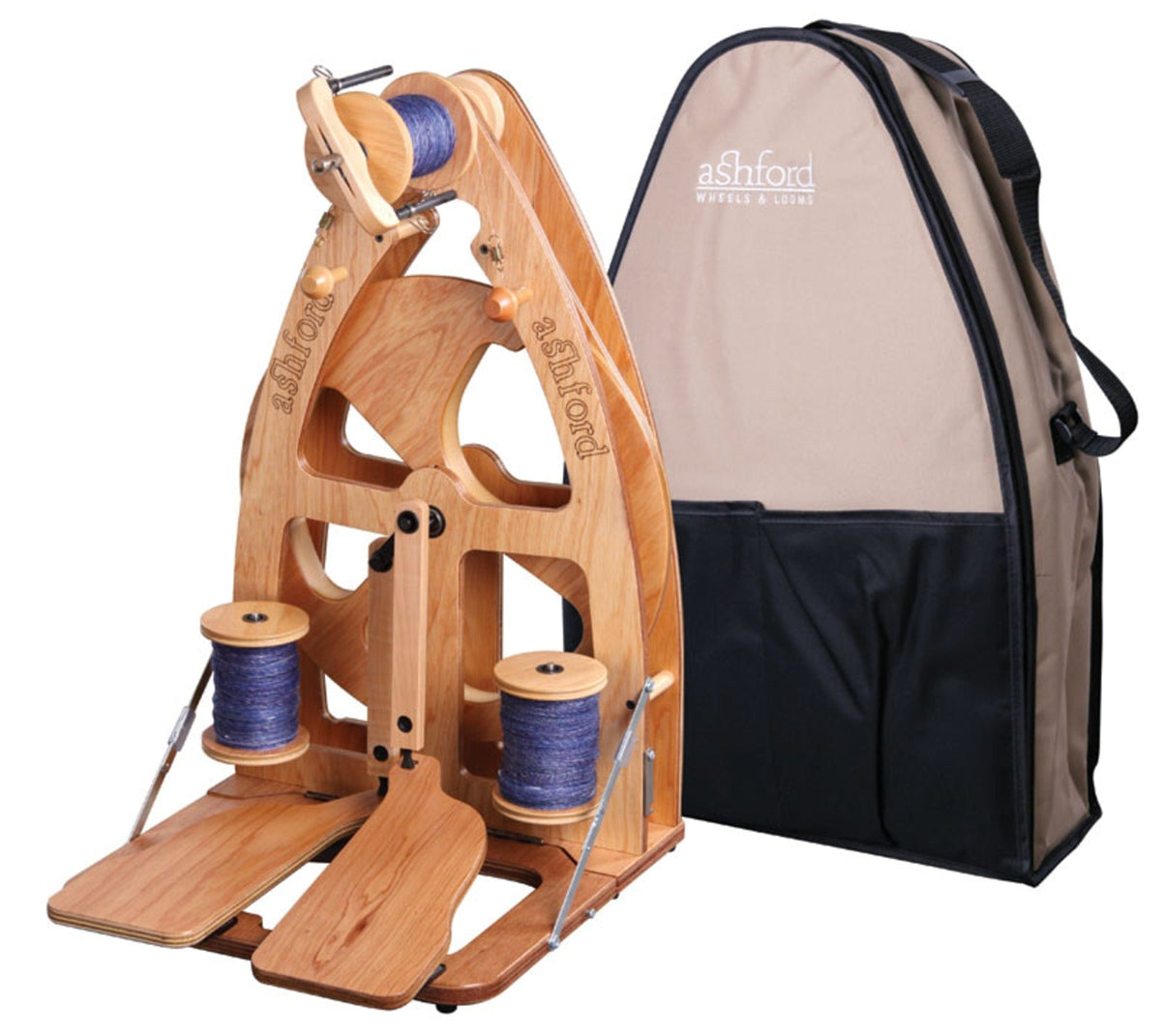 An Ashford Joy 2 Spinning Wheel by Ashford Handicrafts Limited, shown with two blue-filled bobbins and foot pedals, is displayed beside a beige and black carry bag, showcasing its stylish, compact design and convenient portability.