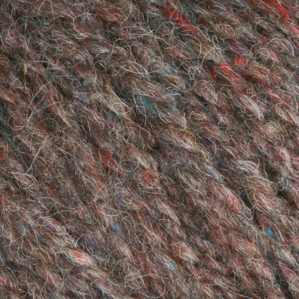 Close-up of Bartlettyarns Maine Wool Yarn (Fisherman 2-Ply) by Bartlettyarns, showcasing its soft, fuzzy texture and intertwined fibers in multicolored shades of brown, red, blue, and gray.