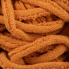 Close-up of tangled, textured Harrisville Potholder Loops - Traditional Size by Friendly Loom with intricate looping patterns reminiscent of cotton loops on a traditional loom. The soft, fuzzy surface of these loops is densely intertwined, creating a visually complex and warm composition.