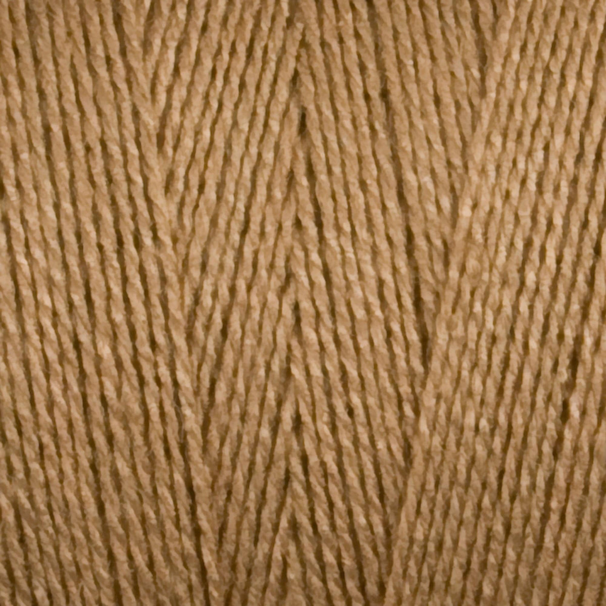 Close-up of light brown 8/2 Tencel Yarn | Mini-cone by Maurice Brassard, showing soft cellulose fibers and parallel strands—ideal texture for detailed weaving projects.
