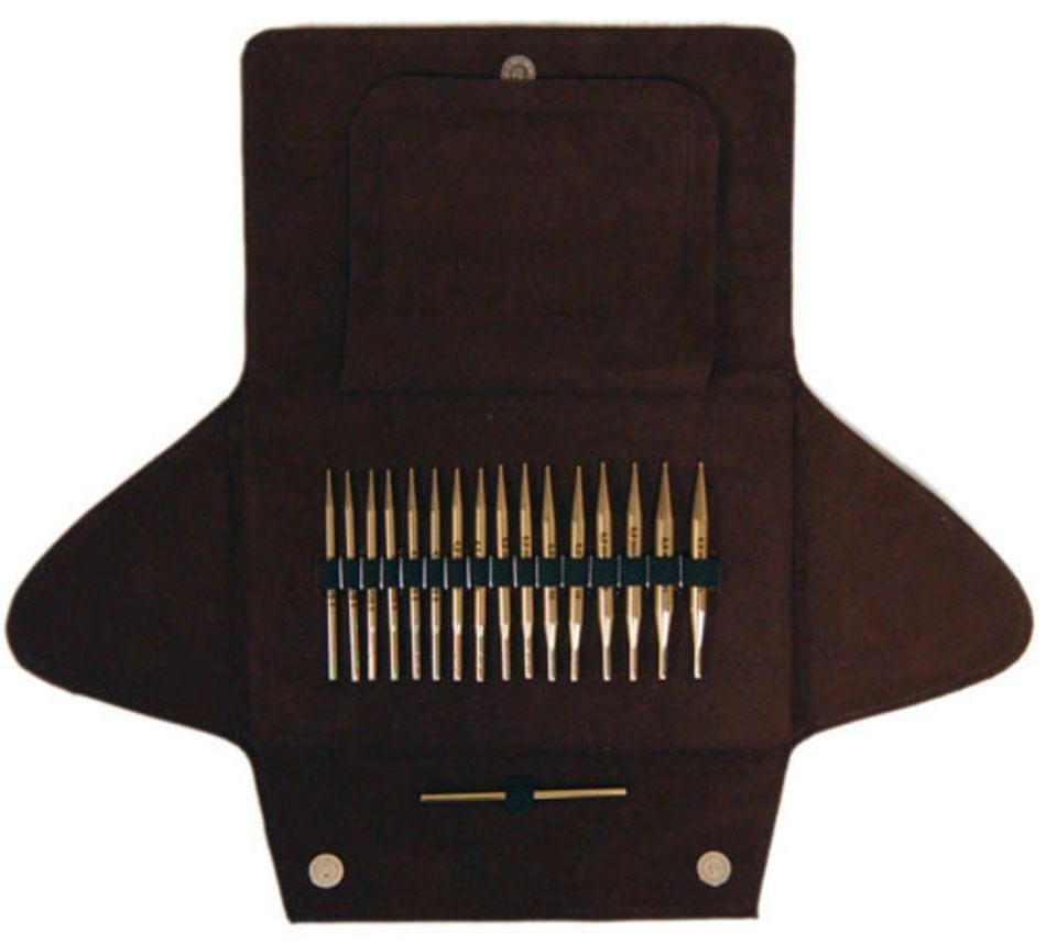 The Skacel Addi-Click Interchangeable Bamboo Needle Set features neatly organized needles in a brown fabric case with three open flaps and a pocket above the needles.